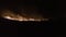 Australian bushfire, fire is moving over a hill near Lake Argyle, Western Australia