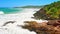 Australian coast, view from a cliff to the blue ocean with a rocky shore on a sunny day. Sea landscape, waves crashing on rocks