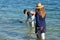 Australian Department of Parks and Wildlife ranger and volunteer feeding dolphins in Monkey Mia