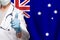 Australian doctor`s hand showing thumb up positive gesture on flag of Australia background
