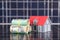 Australian dollar bills and house model on solar panel background