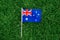 Australian flag lying on green grass. Australia day national holiday celebration. Nature background outdoors