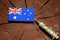 Australian flag on a stump with syringe injecting money