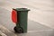 Australian garbage wheelie bin with red lid