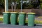 Australian garbage wheelie bins with colourful lids for recycling household waste on the street kerbside for council rubbish