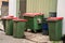 Australian garbage wheelie bins with red lids