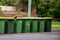 Australian garbage wheelie bins with yellow lids for recycling household waste lined up on the street kerbside for council rubbish