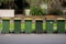 Australian garbage wheelie bins with yellow lids for recycling household waste lined up on the street kerbside for council rubbish