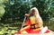 Australian girl enjoying kayak ride on beautiful pond