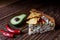 Australian meat pie on the table and avocado, chilli, chips a horizontal top view, rustic style.