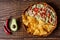 Australian meat pie on the table and avocado, chilli, chips a horizontal top view, rustic style.