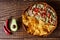 Australian meat pie on the table and avocado, chilli, chips a horizontal top view, rustic style.