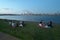 Australian people having a weekend picnic on Swan river against Perth central business district skyline