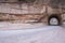 Australian unsealed road traveling through a sandstone tunnel