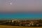 Australian urban landscape at blue hour by full moon in hazy sky