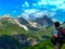 Austria. Alps. A hiker is looking into the distance. A hiker with a backpack looks at the rocks.