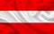 Austria country flag on wavy silk fabric background