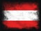 Austria Flag design composition of exploding powder and paint, isolated on a black background for copy space. Colorful abstract