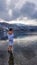 Austria - A girl in a white bathrobe walking in a shallow water of a lake