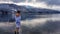 Austria - A girl in a white bathrobe walking in a shallow water of a lake