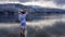 Austria - A girl in a white bathrobe walking in a shallow water of a lake