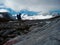 Austria. Glacier `hallstÃ¤tter.` A hiker looks at the glacier through a cloud.