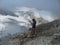 Austria. The mountainous region is a `Dachstein`. A hiker looks at the glacier through a cloud.