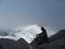 Austria. The mountainous region is a & x22;Dachstein& x22;. A hiker looks at the glacier through a cloud.