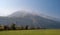 Austrian Alps in the morning. Towers power lines with lots of wires leaving the mountain. Light fog in the mountains. In