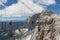 Austrian Dachstein Mountains with hikers passing a skywalk rope