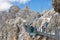 Austrian Dachstein Mountains with hikers passing a skywalk rope bridge