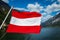 Austrian flag against mountain lake