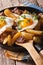 Austrian food: fried potatoes with meat and eggs in a pan closeu