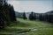 Austrian landscape in the morning with a tiny river in the foreground