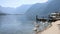 Austrian village, Swans eating in the muddy water of the lake, shore of the lake, Alps view