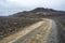 Austurleid road coming through desert hills covered with volcanic sender and rocks