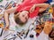 Authentic artist children girl paints on floor. Top view.