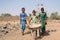 Authentic Black Schoolgirl Transporting pure Water in a village