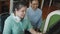 Authentic blind person woman with headphone using computer with braille display assistive device discussing with senior colleague