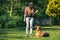 Authentic casual woman teaching dog obedience