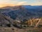 Authentic city with serpentine dirt road in the rock. Vintage Dagestani mountain village of Gunib in sunrise. Russia