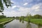 Authentic Dutch landscape with river Kromme Rijn, walkway, clouds and trees