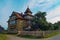 Authentic Hutsul Dwelling in the Carpathians: A Sunny Summer Day Amidst the Forest. Traditional Two-Story Village House