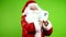 Authentic joyful Santa Claus in red suit dancing and funny waving hands.