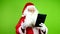 Authentic joyful Santa Claus talk Christmas online congratulation of his tablet.