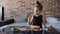 A authentic little girl is eating spaghetti pasta with nuggets and tomato with a fork at the table