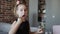 A authentic little girl is eating spaghetti pasta with nuggets and tomato with a fork at the table