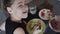 A authentic little girl is eating spaghetti pasta with nuggets and tomato with a fork at the table