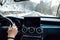 Authentic portrait of driver on mountain curvy roads. Driver hands and point of view