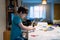 Authentic portrait of Preschool kid putting glue stick on paper for his school homework, Young boy using glue stick on paper